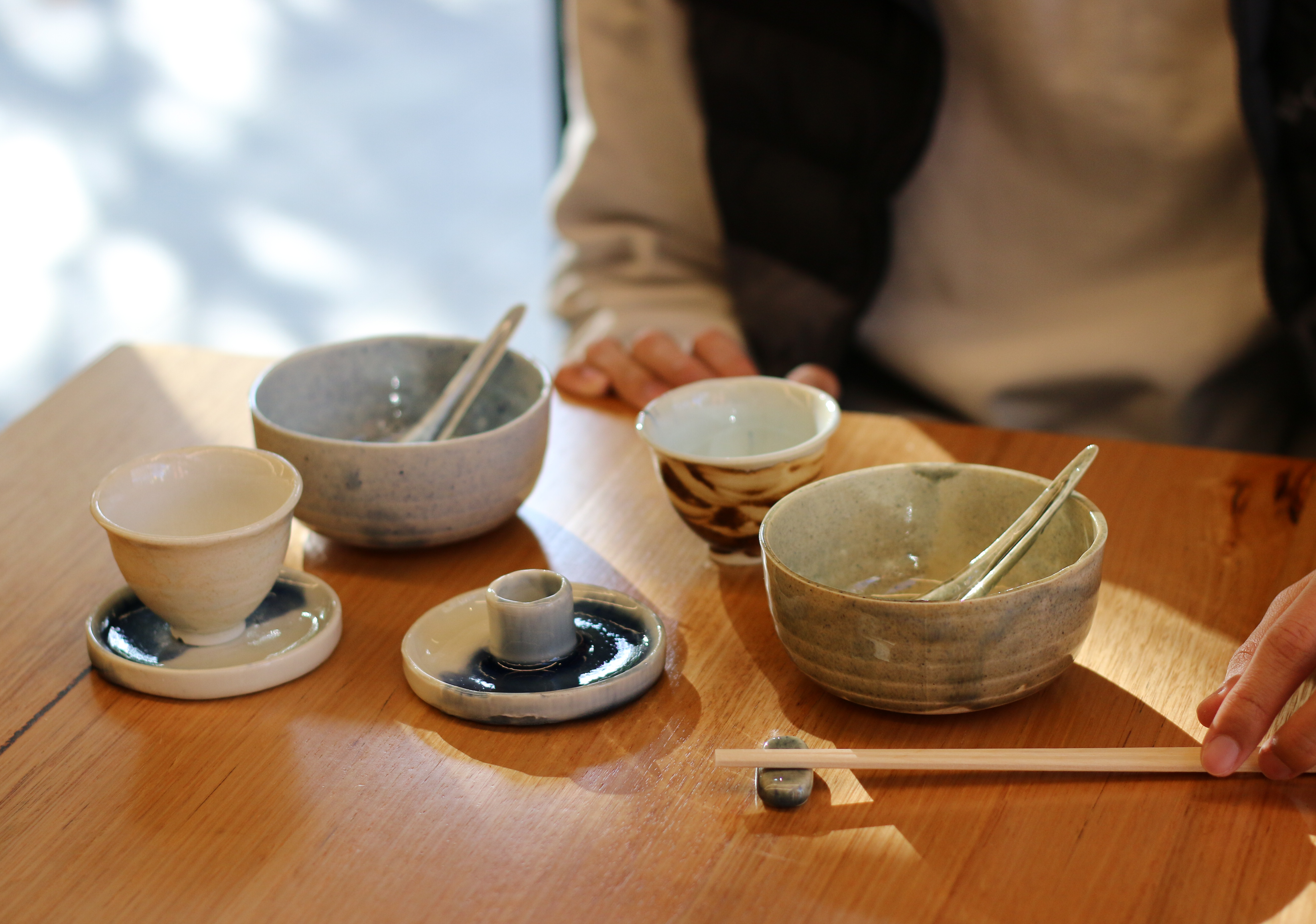 Ceramic objects laid in front of a person