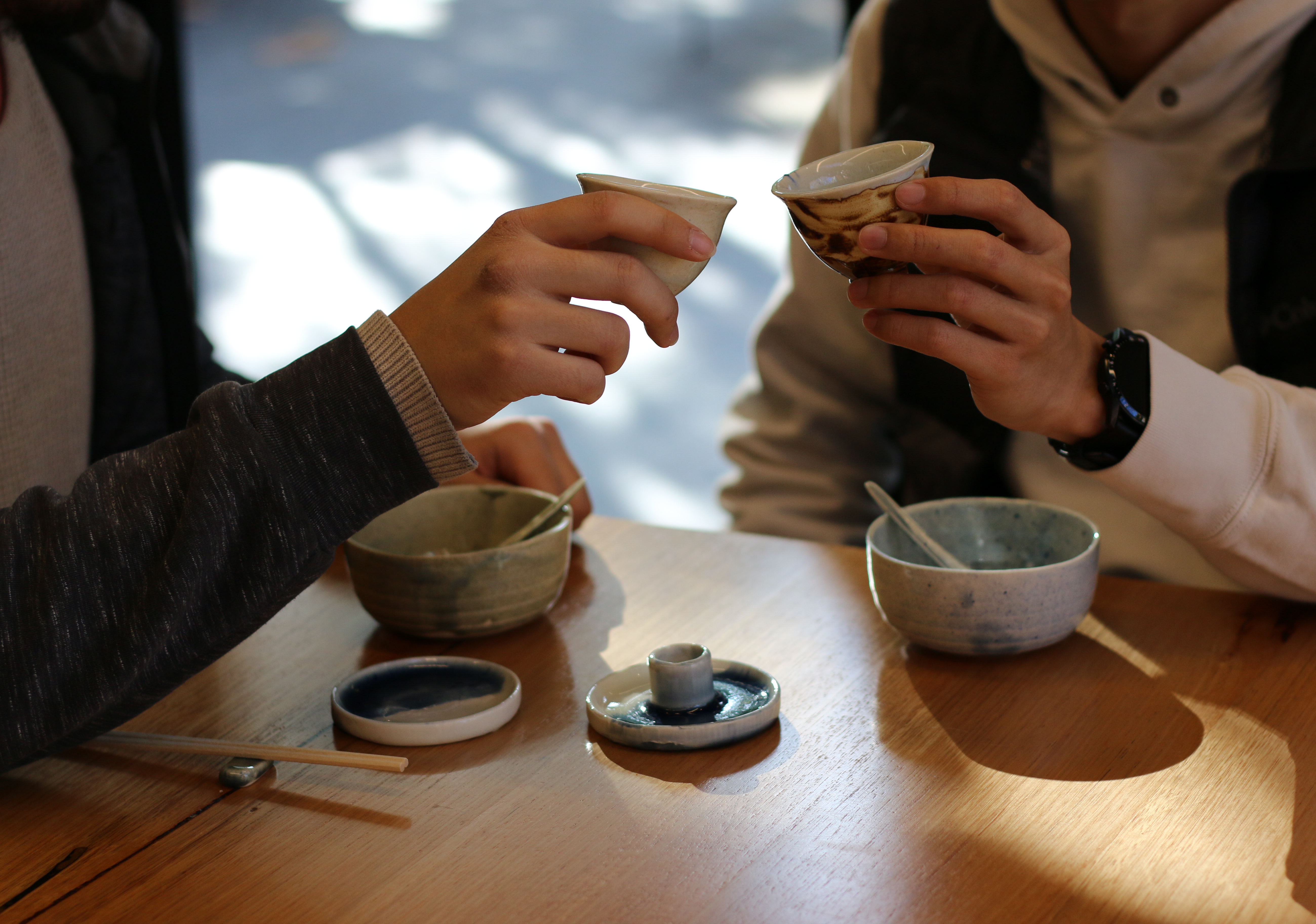 Two people holding cups